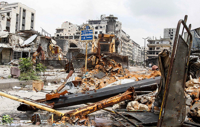 A bulldozer removes debris at al-Hamdeya neighborhood in Homs city May 9, 2014.