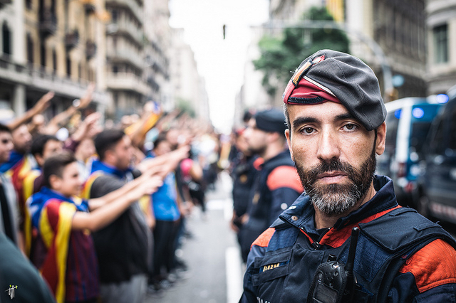 Catalan police officer and protestors. Barcelona, October 2017.